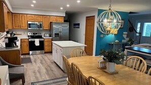 A modern kitchen with wooden cabinets, stainless steel appliances, and a central island. - Close to the Beach, Pet Friendly/Tesla Charger/2-3 Night Stays Off Season (Milton)