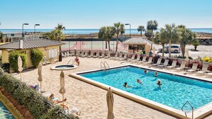 A swimming pool area with lounge chairs and umbrellas, a small hot tub, and a view of the beach. - 🌊 Islander #601 -Gulf Views of the Most Beautiful Beaches in the World! 🏖️ (Destin)