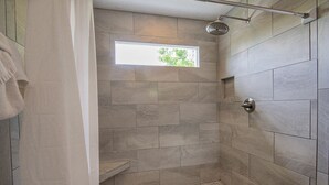 A shower with a window, tiled walls, and a towel hanging on the door. - Our Tennessee Mountain Home - Great Location!  Close To All The Action! (Pigeon Forge)