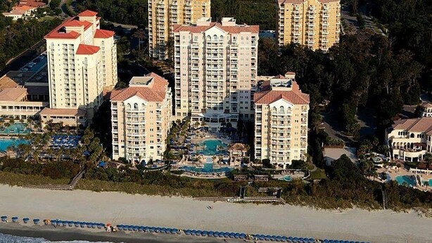 A coastal hotel complex with multiple high-rise buildings, a beachfront, and a pool area. - MARRIOTT OCEAN WATCH (Myrtle Beach)