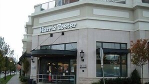 A Harris Teeter store with a modern facade, large windows, and a covered entrance area.