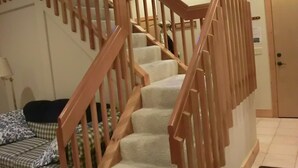 A staircase with wooden railings leading to a landing.