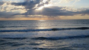 A beach with waves and a sunset. - Oceanfront corner Condo Stunning Views -heated pool Satellite Beach -Cocoa Beach (Satellite Beach)