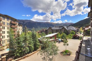 Experience the serene mountain views from the resort's spacious balconies and enjoy a refreshing dip in the pool surrounded by lush trees.