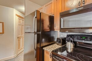 Enjoy cooking in this well-equipped kitchen with a refrigerator, microwave, and toaster.