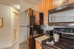 Enjoy cooking in this well-equipped kitchen with a refrigerator, microwave, and toaster.
