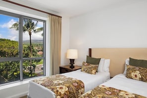 A hotel room with two beds, a window with a view of palm trees and a road, and a nightstand with a lamp. - Honua Kai | Ocean View 2 BR Sleeps 6 | Car Incl. w/ 6+ Nights | HKK-334 by KBM (Lahaina)