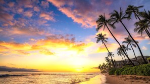 A beach with palm trees and a sunset. - Honua Kai Konea | Ocean View 2 BR | Remodeled Corner Villa | HKK-334 by KBM (Lahaina)
