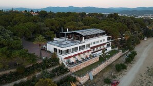 Un bâtiment à deux étages, doté d’un toit plat, de grandes fenêtres et d’un balcon.