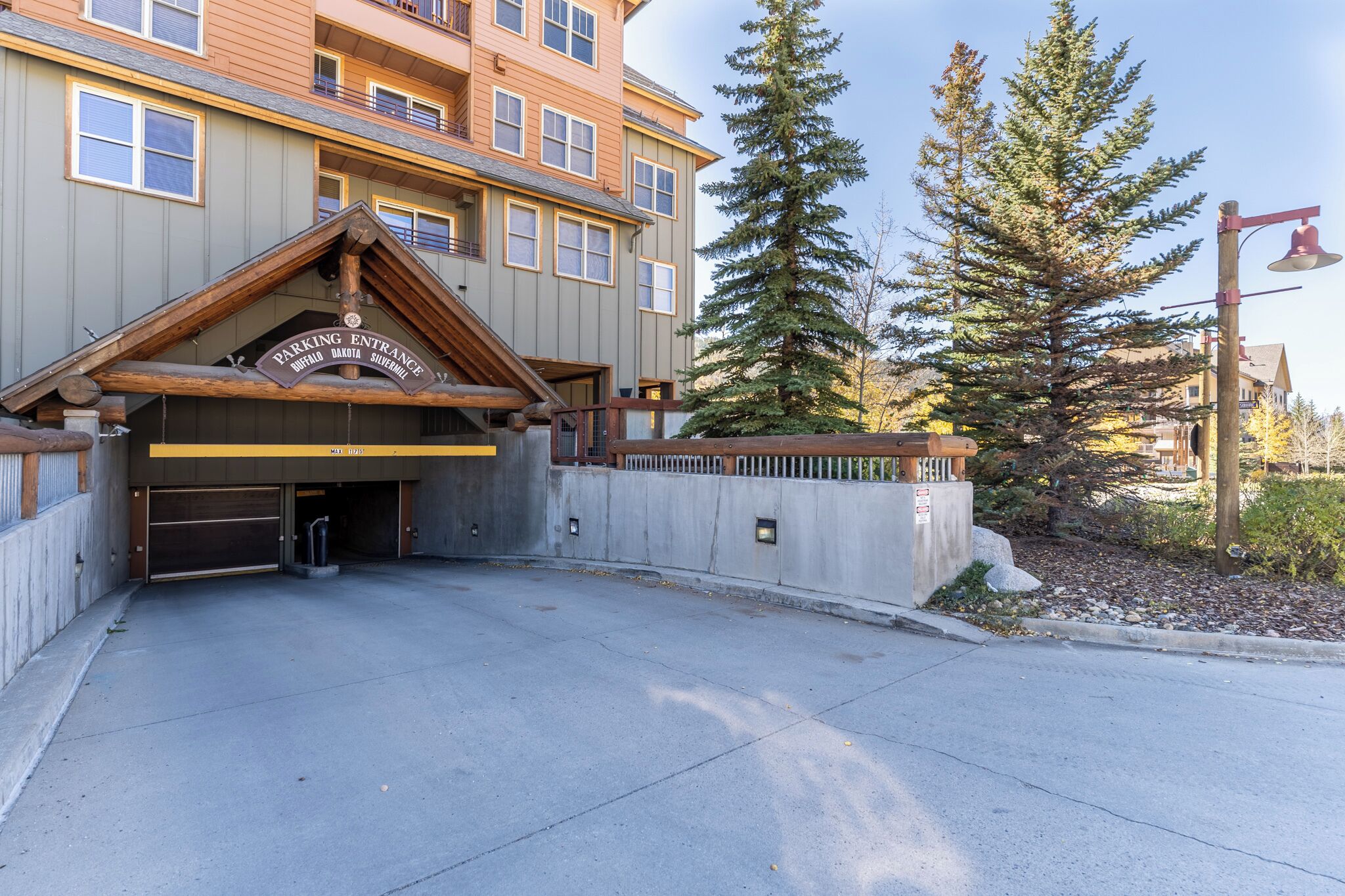 A building with a wooden entrance labeled "PARKING ENTRANCE" and "BUFFALO DAIRY SILVERMINN."