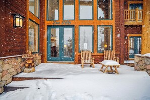 Welcome to Two Flighty, a charming lodge with a warm entrance and inviting Adirondack chairs.
