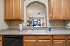 Enjoy cooking in this well-equipped kitchen with a central island, dishwasher, and ample countertop space.