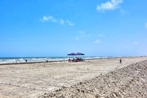 Enjoy a serene beach experience with a shaded area and access to the sandy beach.