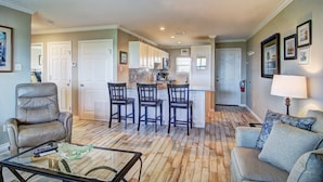A spacious living room with a leather chair, a glass coffee table, and a sofa. - This wonderful condo is located on the 2nd floor of the beachfront building in f (Port Aransas)