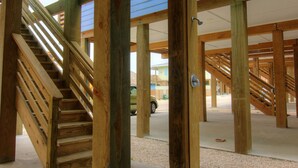 A wooden staircase structure with a vehicle in the background. - You are certainly Shore To Love It! This fabulous island style home is located r (Port Aransas)