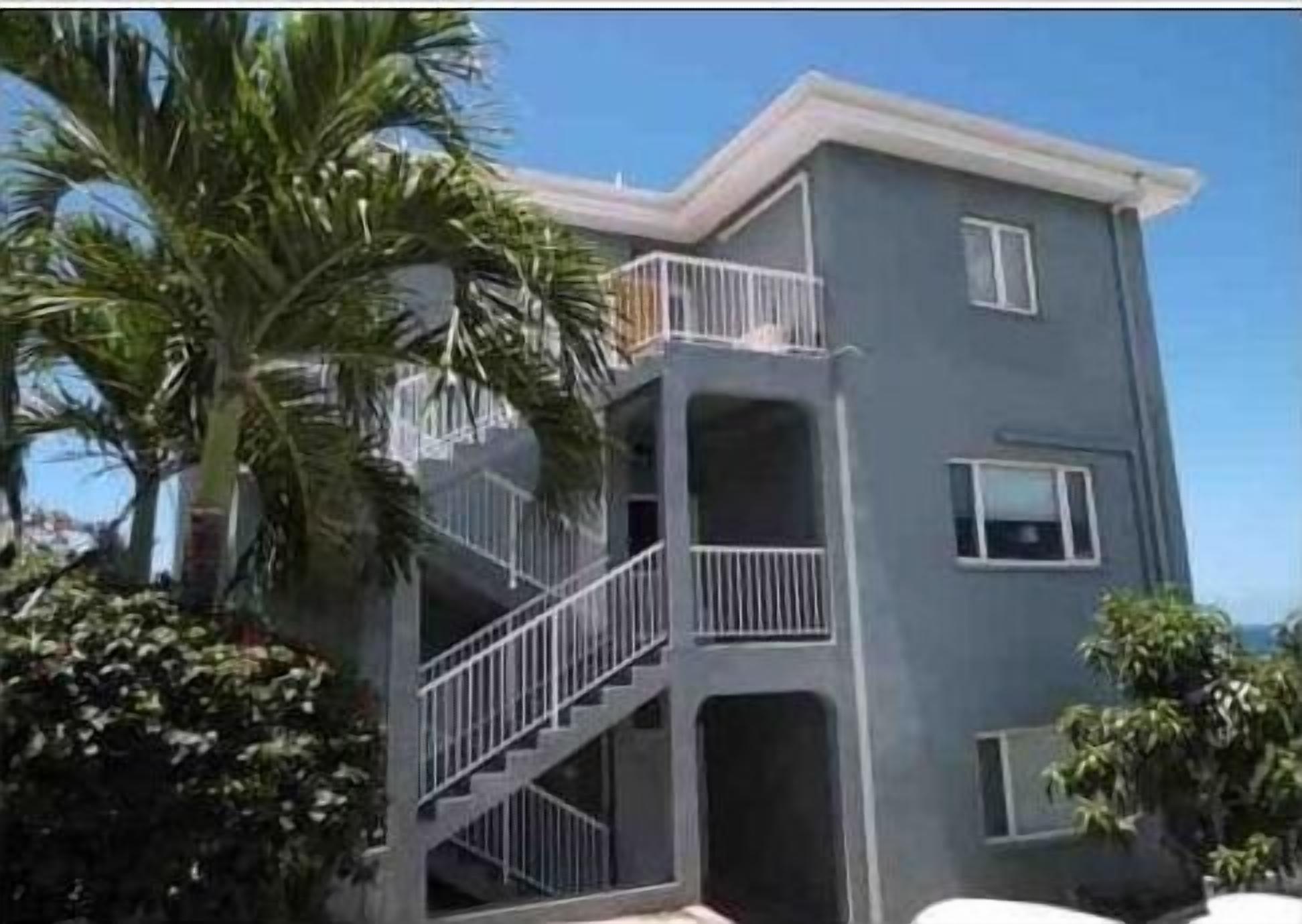 A two-story building with a balcony on the upper floor.
