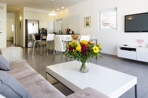 Apartment, 1 Bedroom, 2 Bathrooms, Beachside | Living room | Flat-screen TV