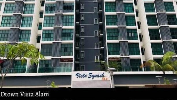 A high-rise building with a modern design, featuring a central vertical structure and multiple balconies. - Ilman's Loft@Vista Alam HILLVIEW-PS4-500MBPS (Shah Alam)