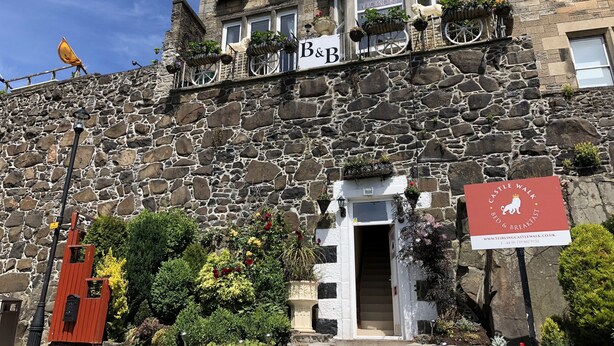 A stone building with a sign for 'Bed & Breakfast' and a 'Castle Walk' sign. - Castle Walk B&B (Stirling)