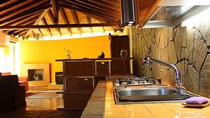 Une cuisine avec un sol carrelé, une cuisinière et un évier.