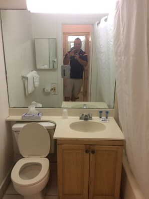 A bathroom with a toilet, sink, and mirror. - Hollywood Beach Resort-spacious Ocean View Studio (Hollywood)