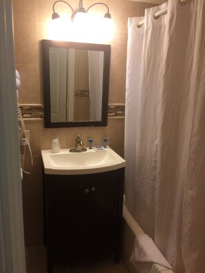 A bathroom with a white sink, a mirror, and a shower curtain. - Hollywood Beach Resort- Beautiful Large Studio , Simply the Best Value (Hollywood)