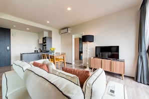 Exclusive Suite, 2 Bedrooms | Living area | 40-inch flat-screen TV with cable channels, TV, DVD player - The Deck Patong (Patong)