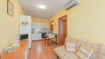 Apartment, 1 Bedroom | Living room | Flat-screen TV