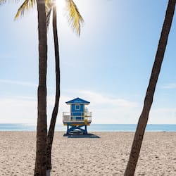On the beach, white sand, beach cabanas, sun-loungers