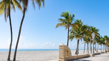 On the beach, white sand, beach cabanas, sun-loungers