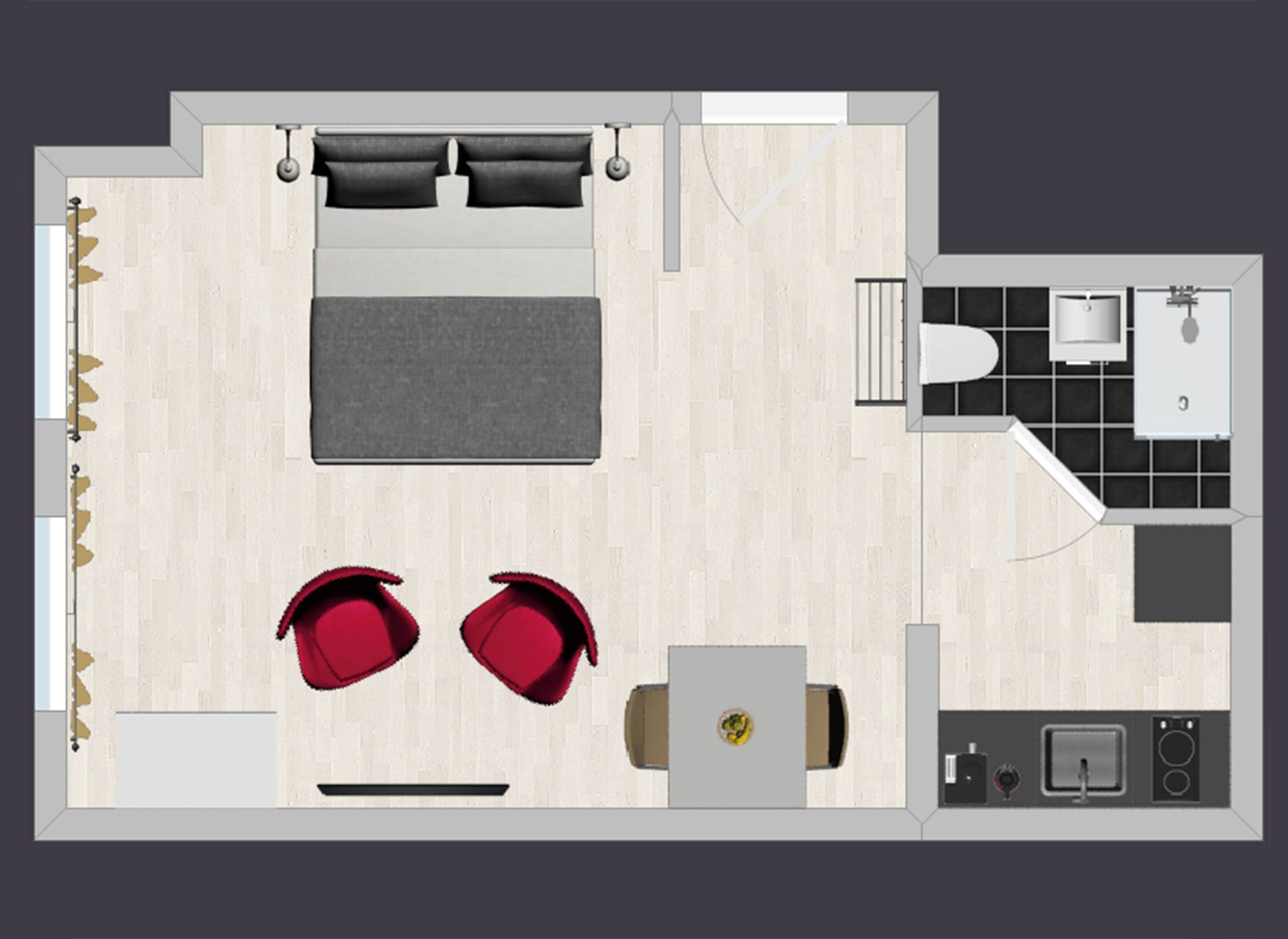 A hotel room layout with a bed, two red chairs, a small table, a desk, and a kitchenette.
