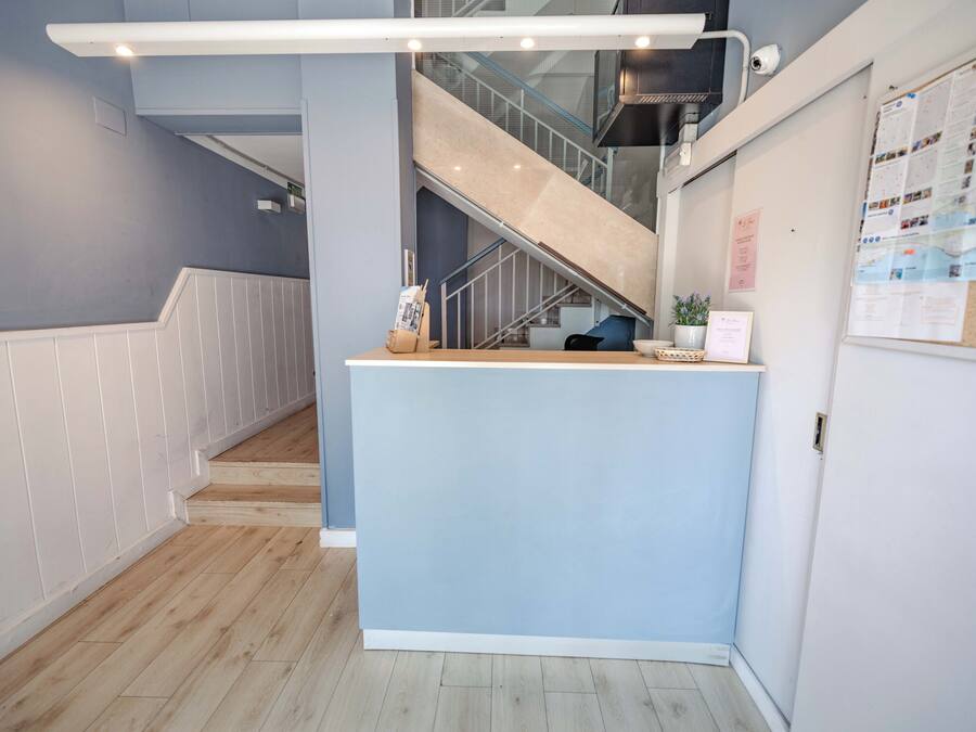 A reception desk with a staircase in the background.
