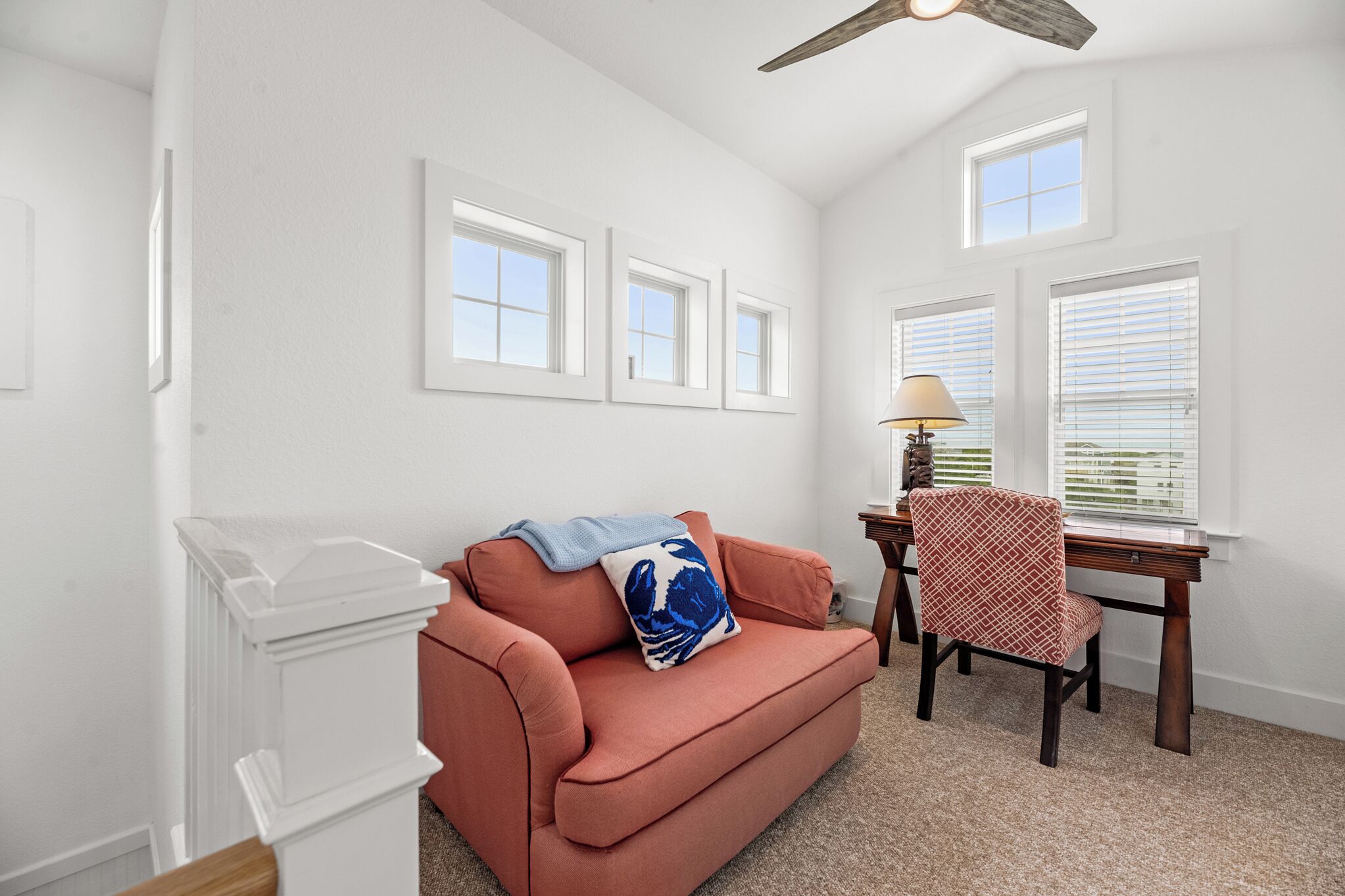 A living room with a sofa, a table, and a lamp.