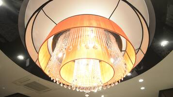 A chandelier with a circular design and hanging crystals.