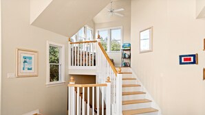 A staircase with white railings and wooden steps leading to an upper floor. - Mon-Elisa: Private Pool, Hot Tub, Club Access (Corolla)
