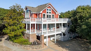 A two-story house with a balcony and a covered porch. - Mon-Elisa: Private Pool, Hot Tub, Club Access (Corolla)