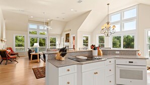 A spacious kitchen with a large island, white cabinetry, and a built-in oven. - Mon-Elisa: Private Pool, Hot Tub, Club Access (Corolla)