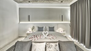 A modern bedroom with a large bed, two bedside tables, a wardrobe, and a curtain-covered window. - Chan Boutique (Sihanoukville)