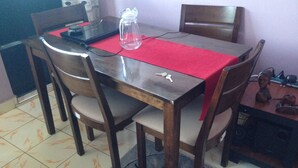 A dining table with chairs, a pitcher, and keys on the table. - Tulos Apartment (Ruiru)