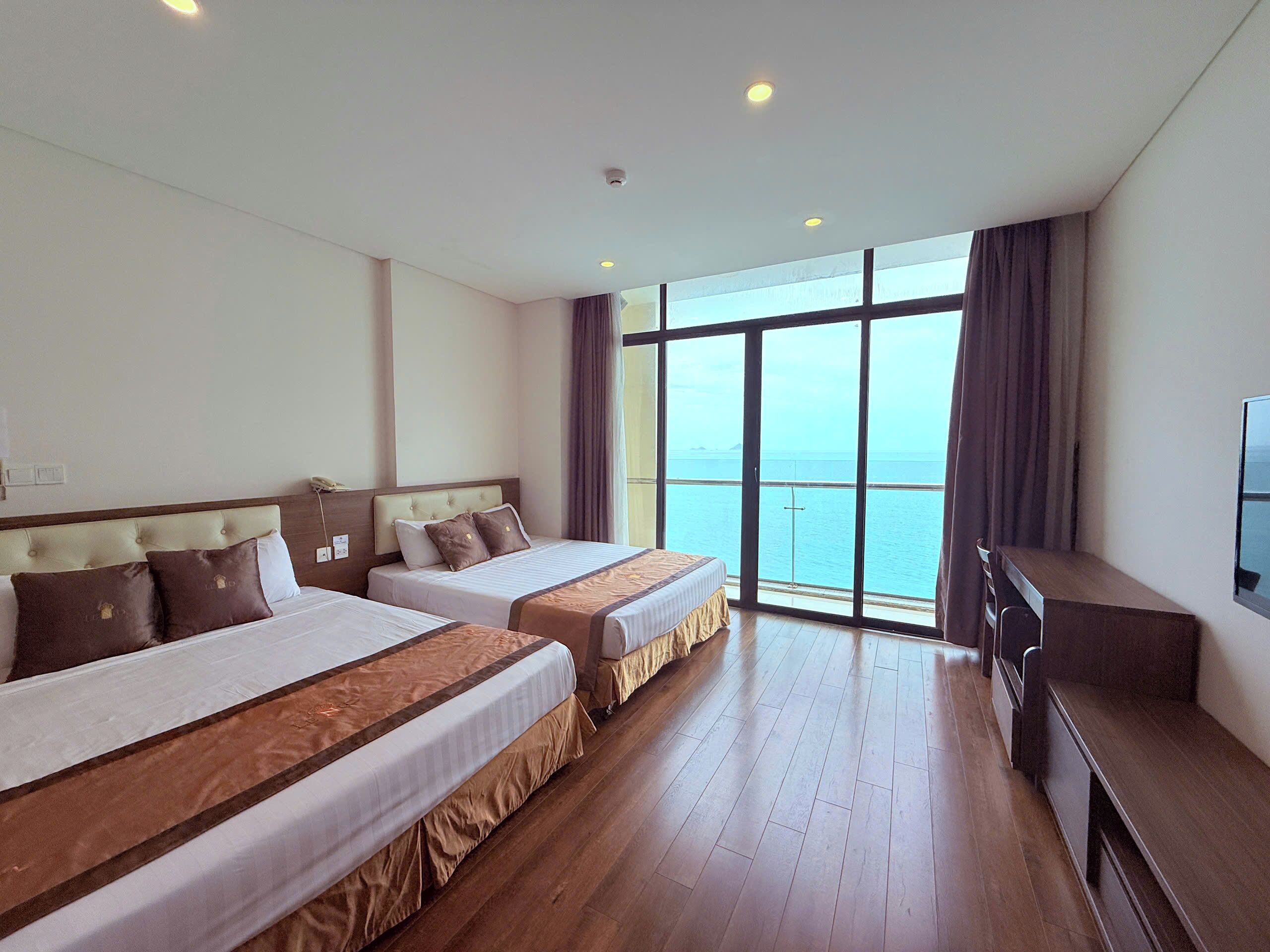 Deluxe Quadruple Room, 1 Bedroom, Sea View | Premium bedding, minibar, in-room safe, desk