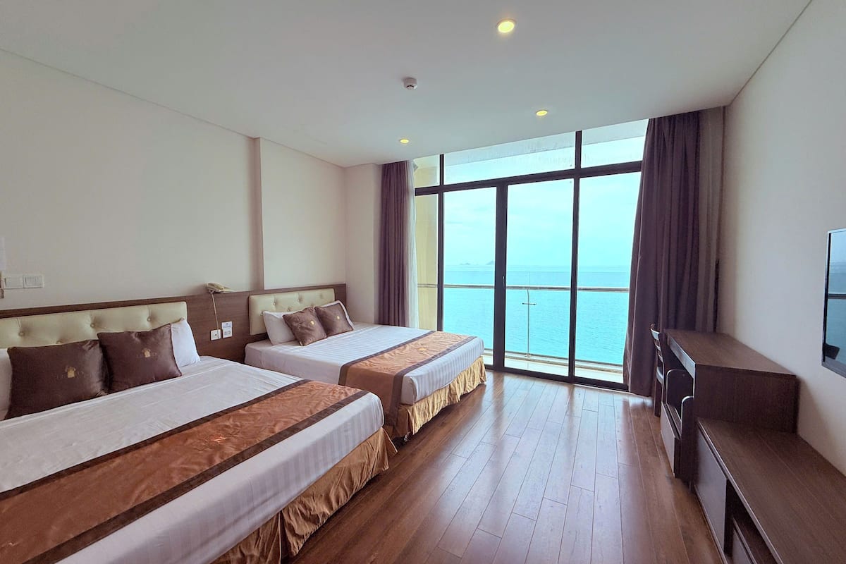 Deluxe Quadruple Room, 1 Bedroom, Sea View | Premium bedding, minibar, in-room safe, desk