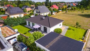 A residential area with houses, a lawn, and a car parked in the driveway. - Usedom tourist Karlshagen House Frieda - House Frieda (Karlshagen)