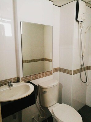 A bathroom with a sink, toilet, and shower. - 88 Living (Bangkok)