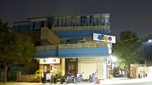 A multi-story building with a sign indicating a stop sign. - goStops Jodhpur - Hostel (Jodhpur)