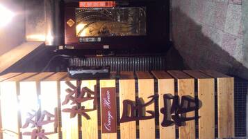 A wooden structure with Chinese characters and a sign that reads "Orange House."