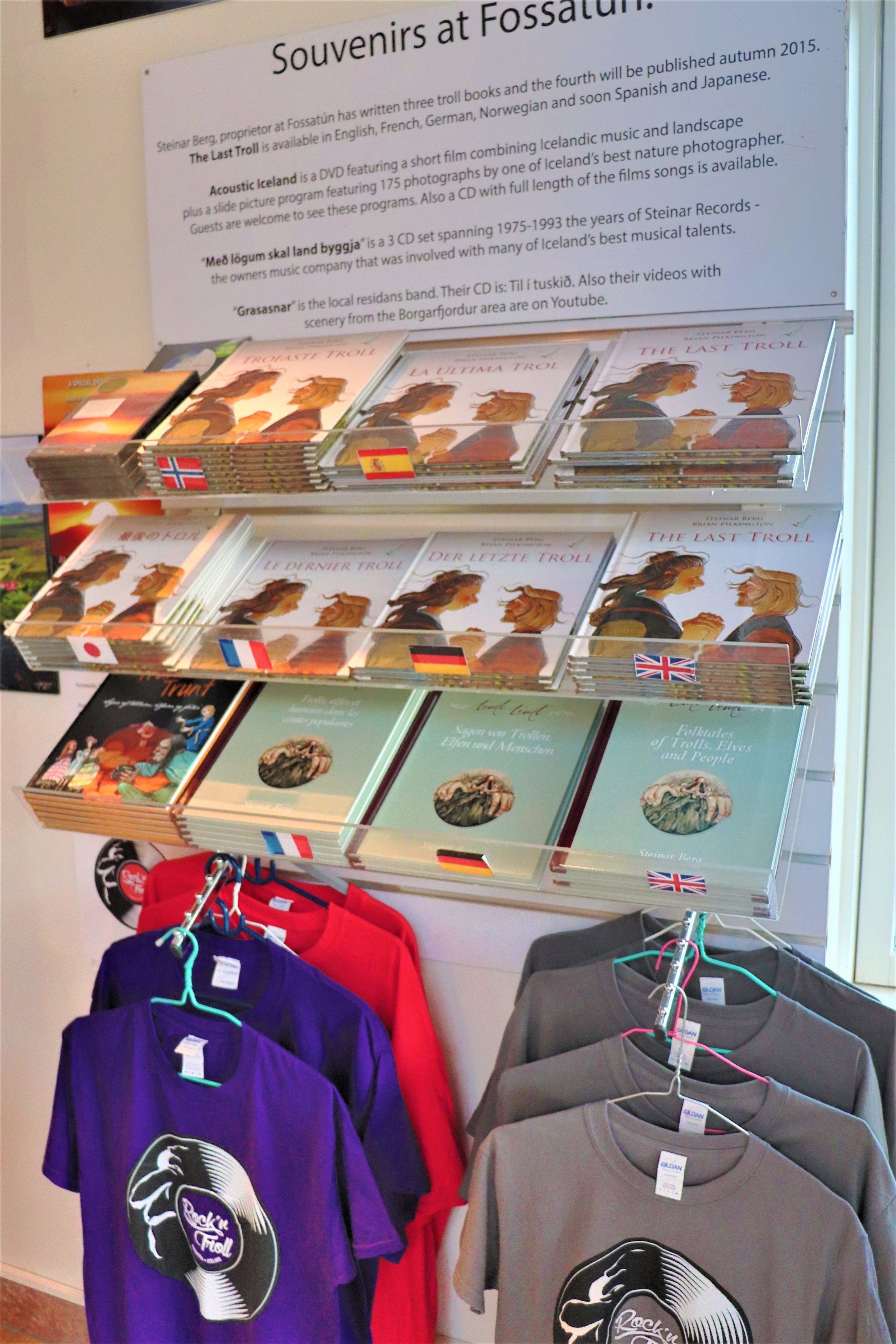 A display of souvenirs including CDs and T-shirts with a troll theme.