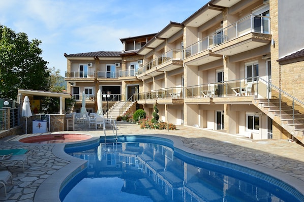 Outdoor pool, pool umbrellas, sun loungers