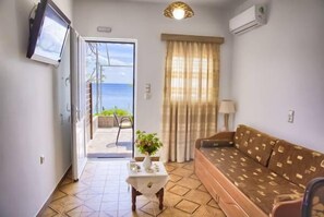 Deluxe Apartment, 1 Bedroom, Terrace, Sea View | Living room | 32-inch flat-screen TV with satellite channels, TV - Haraki Dream View (Rhodes)