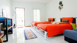 A modern bedroom with two beds, a desk, and a chair. - Panida Goodwill (Nong Hin)