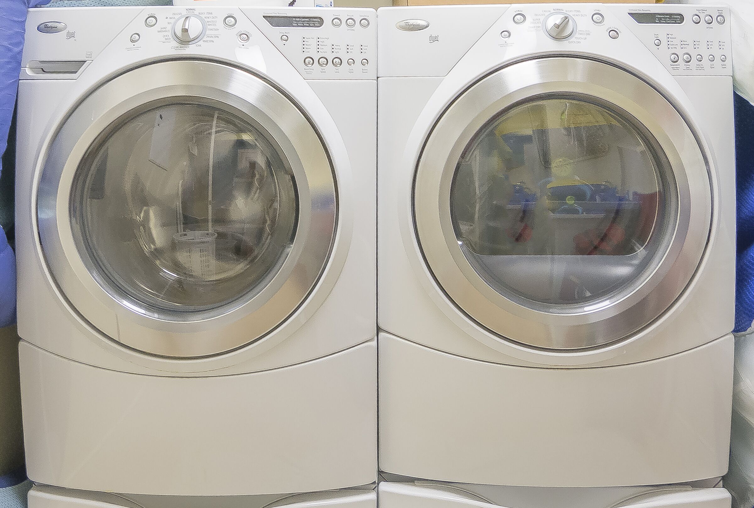 Two front-loading washing machines with control panels.